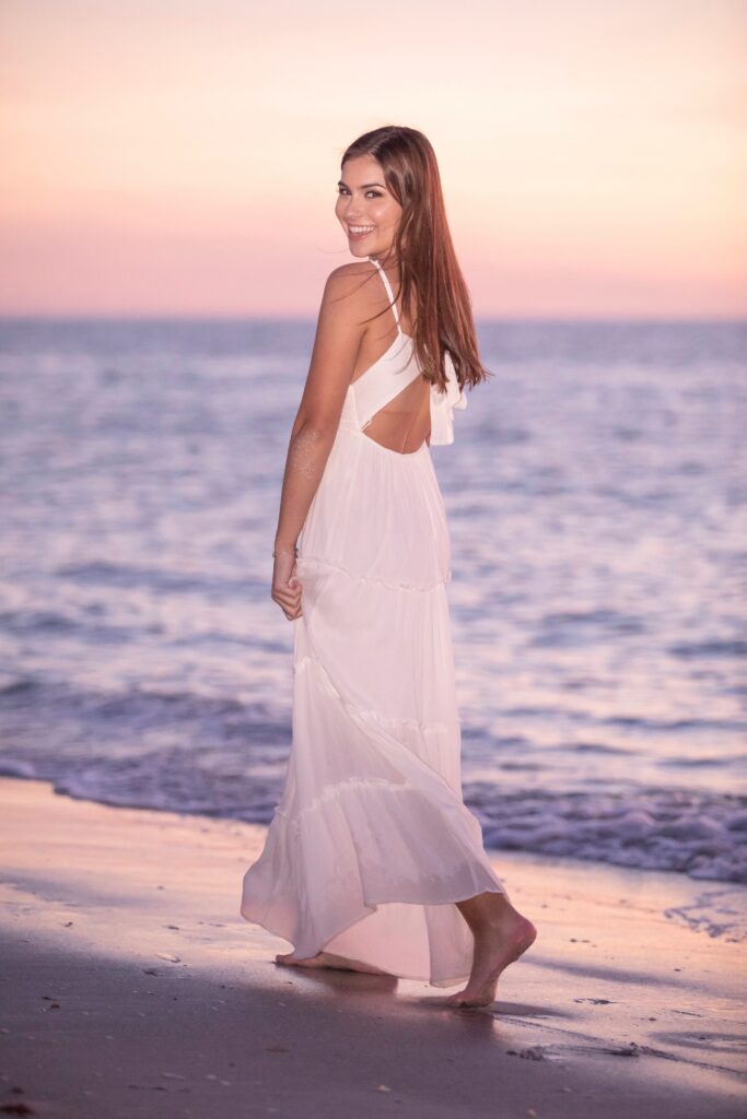 senior girl wearing a simple white dress for her senior photo outfit