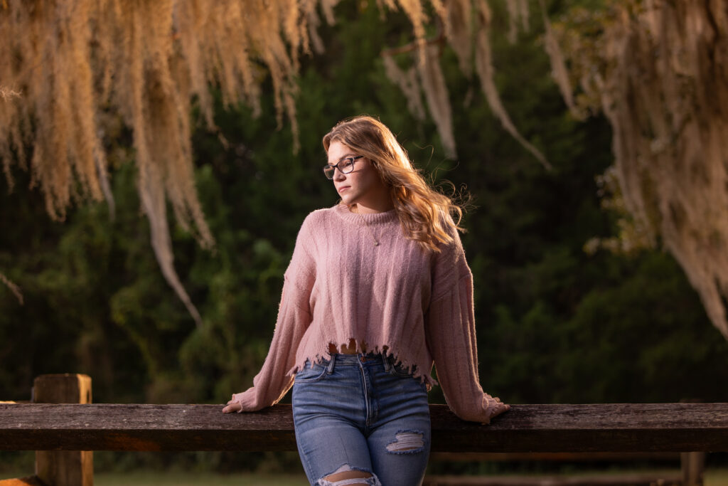 high school senior posing in front of draping oak tress for senior portraits in Tampa