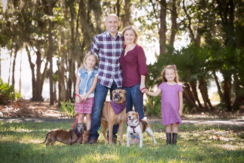 family of 4 has a photo shoot with their 3 dogs