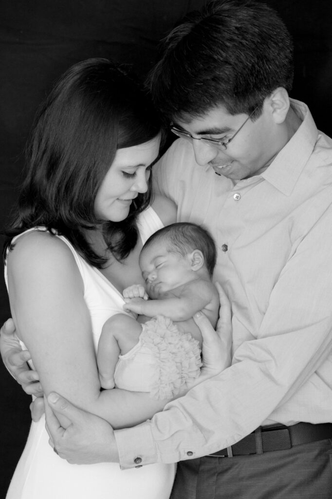 Tampa couple holding their baby during their newborn photo session