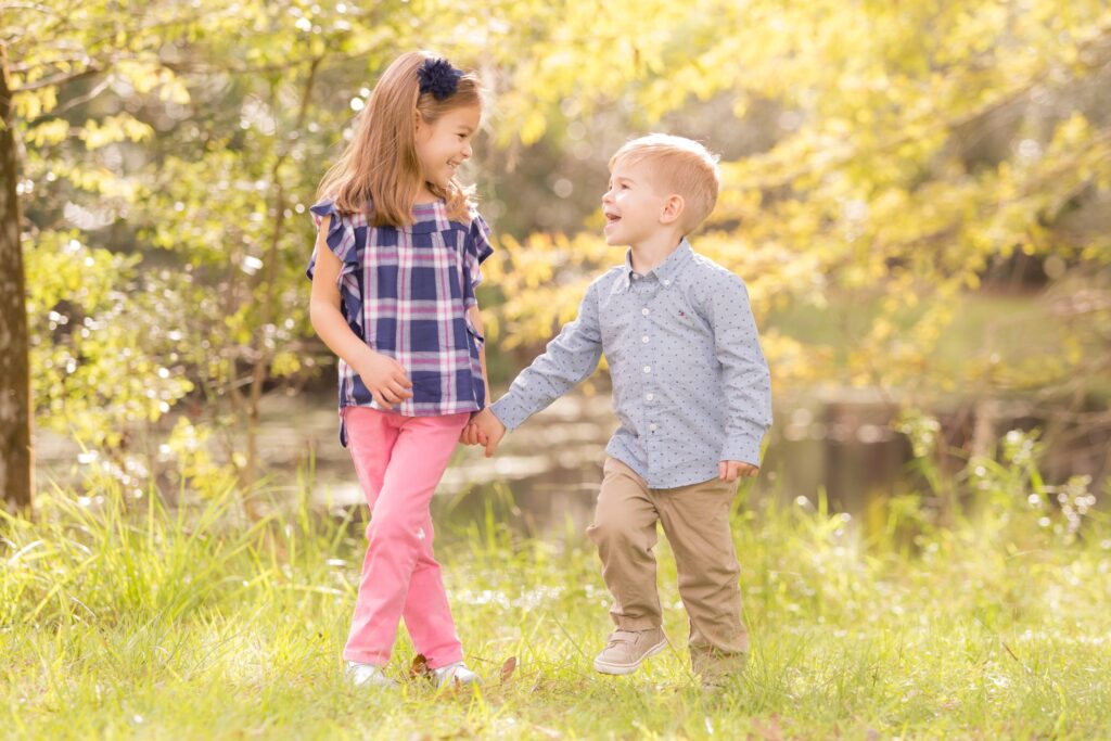 brother and sister walking and holding hands during their family photoshoot