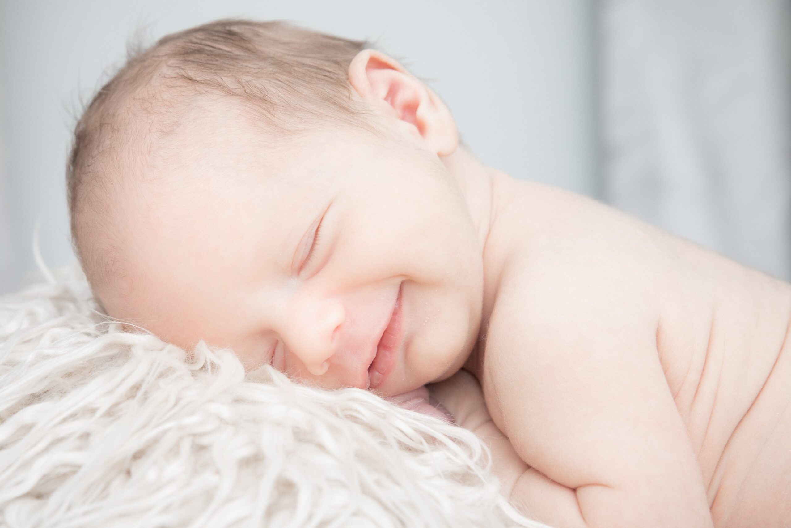newborn smiling during newborn photoshoot