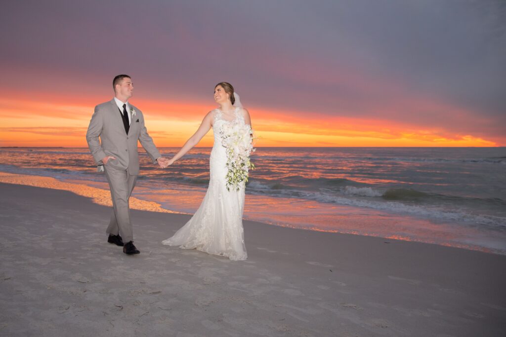 Wedding couple walking on St. Pete Beach at sunset