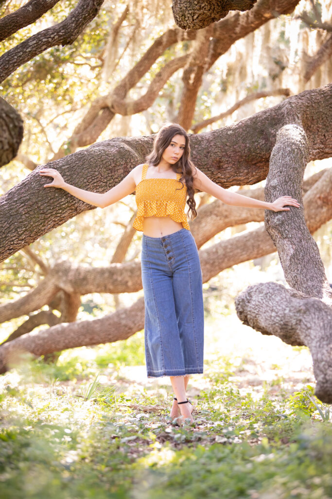 70s style senior picture outfit ideas - yellow crop top and flare jeans