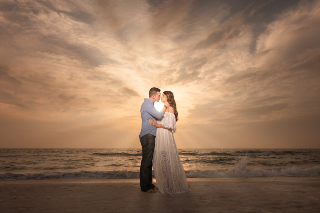 couple almost kissing on the shores of a Tampa beach at sunset - image for blog on how long do professional photos take to get back