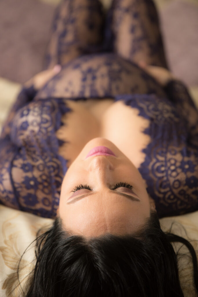 pregnant woman wearing blue lace lingerie for maternity photoshoot outfit