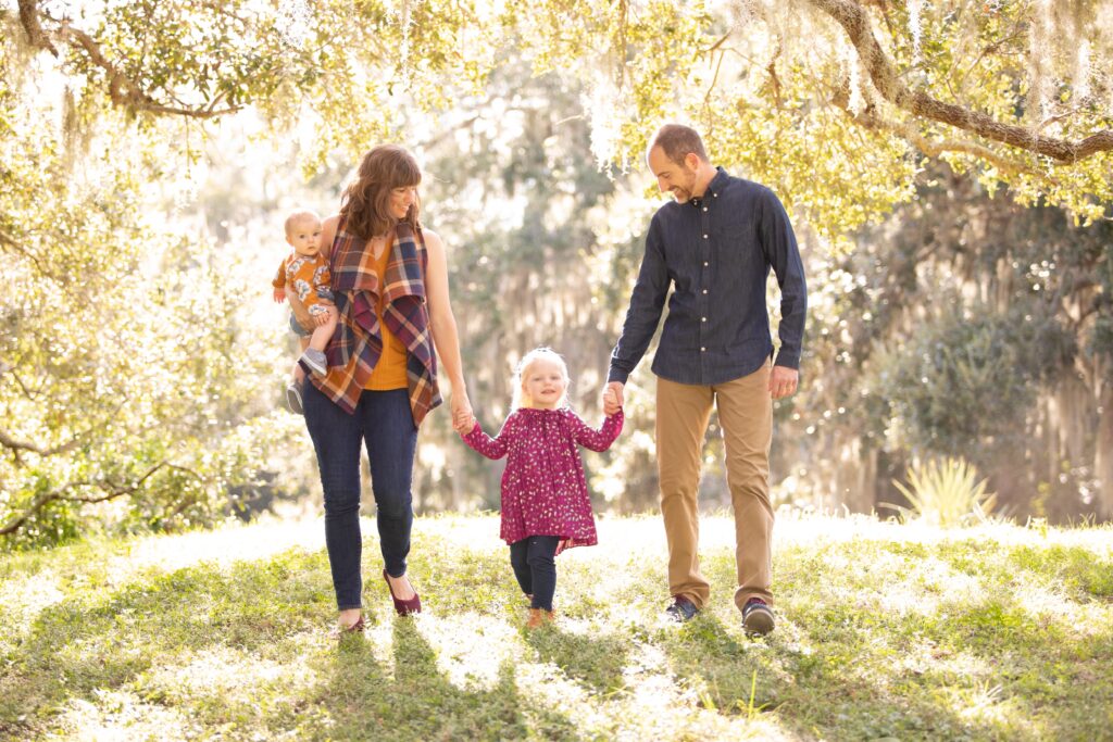 Christmas family photoshoot outfits worn by family of 4 in festive colors in Philippe Park